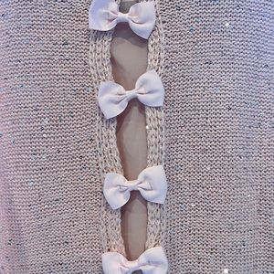 Pink sweater with sequence, bows in the back